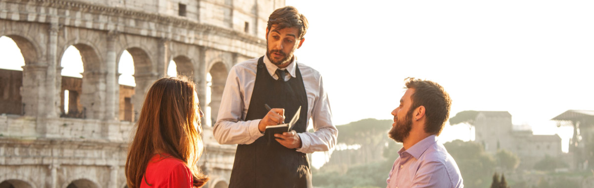 couple at a restaurant in Italy in front of the Colosseum