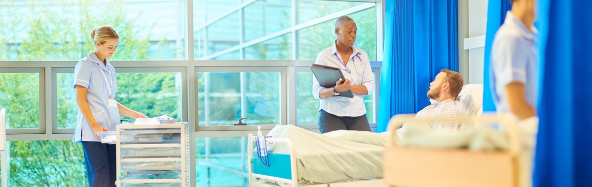 man in hospital with doctor and nurse