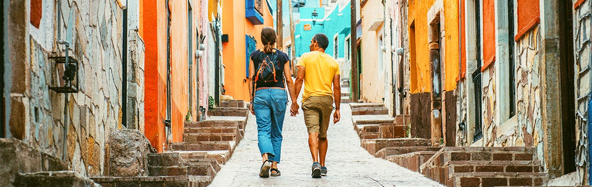 2 people walking the streets in Cancun, Mexico