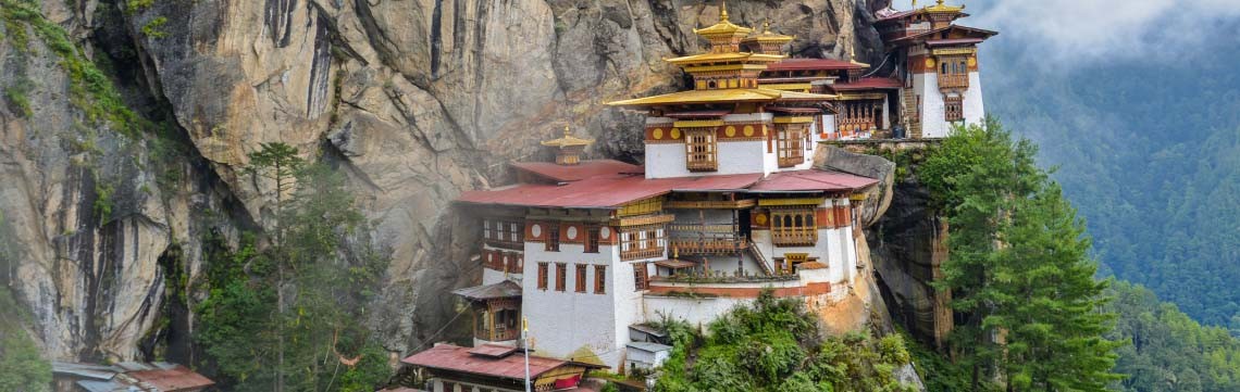 Buddhist monastery clinging to the rocks in the Bhutan mountains