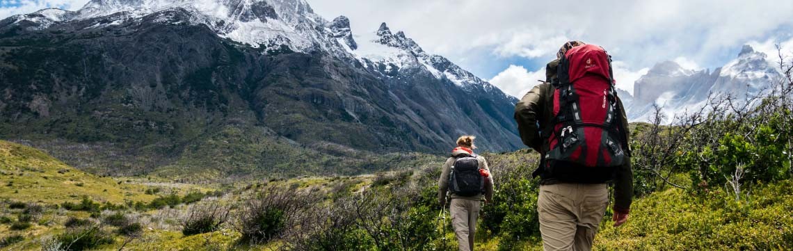 two hikers in the wilds of Patagonia surrounded by mountains
