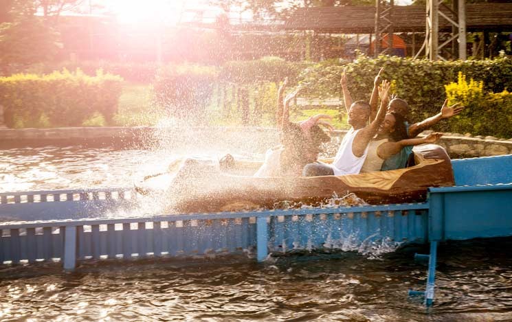 family on a water ride at a theme park