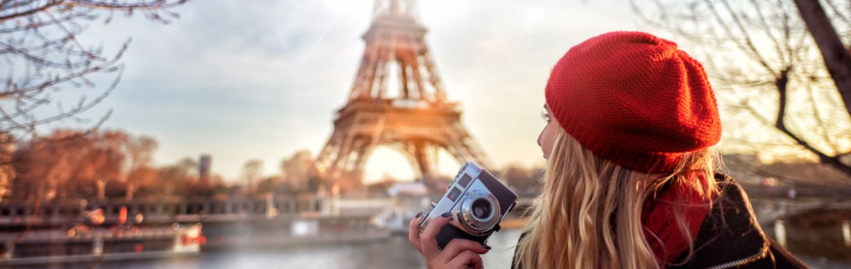 woman with beret looking at the Eiffel Tower in Paris, France