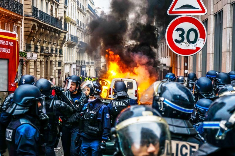 Riot police clash with protesters in Paris, France