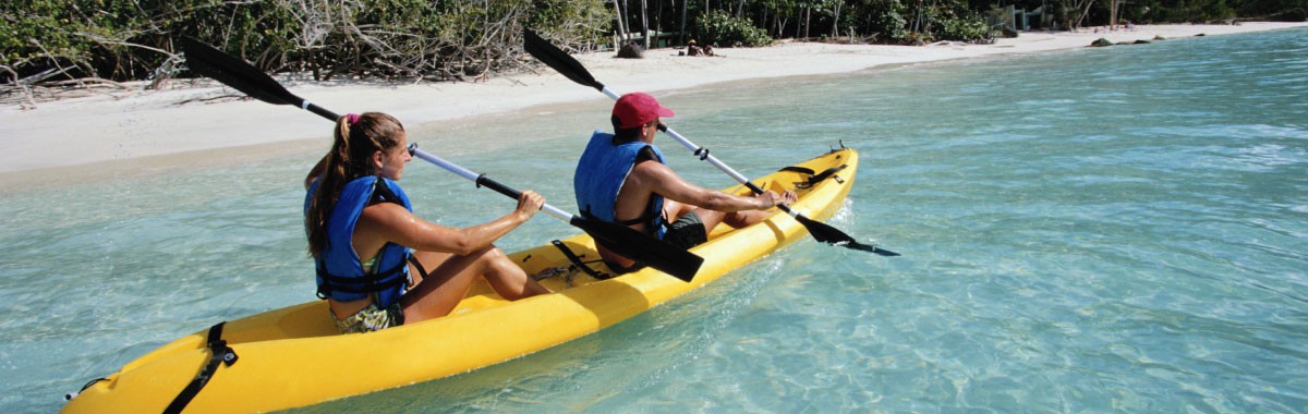 two people in a yellow kayak in the ocean