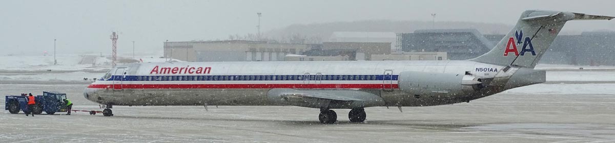 plane on a runway in a winter storm