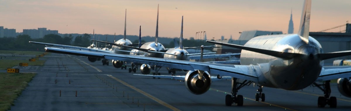 airport runway with line of planes ready to take off