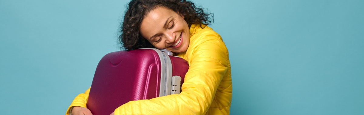 person hugging their luggage